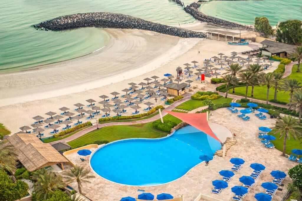Aerial view of the private beach and pool at Coral Beach Resort Sharjah